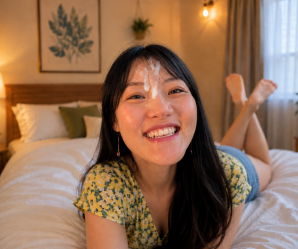 Asian laying down on bed with facial
